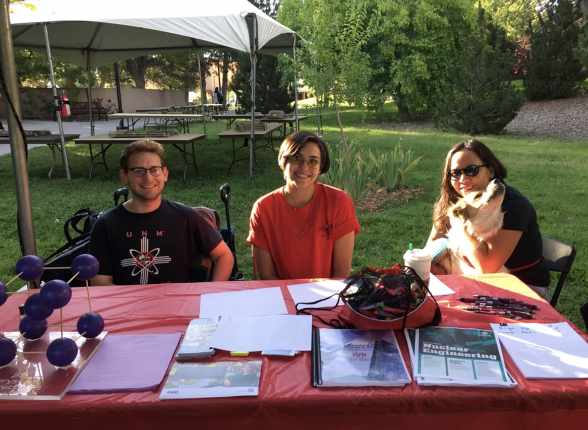 Matthew Gervasi, Alexandria Ragsdale, and Ira Strong (with Sancho the dog) attend the ANS Welcome Back Days booth in 2019 at the UNM Duck Pond.