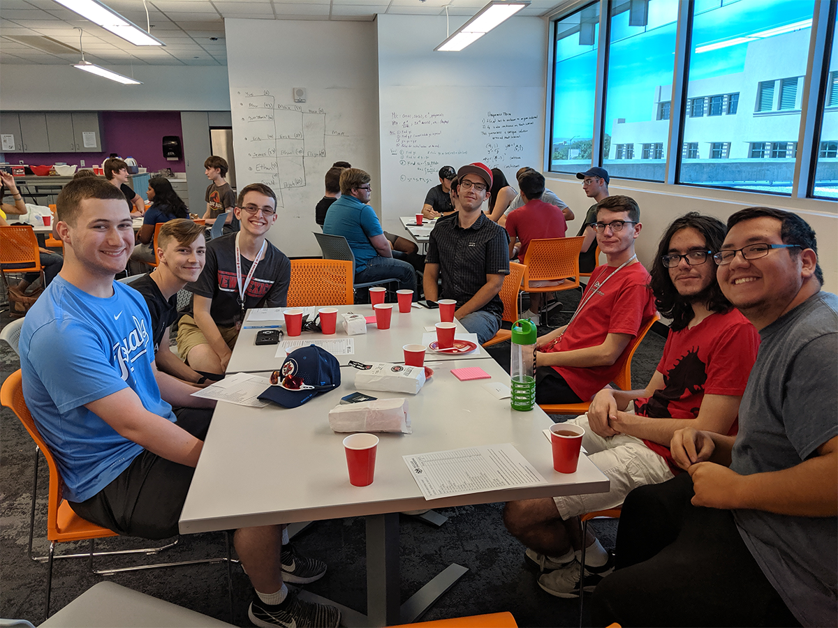 photo of many students sitting around a table